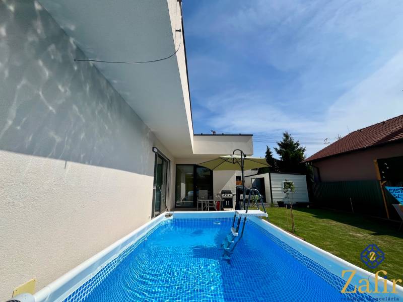 A family house in Trnava with a garden pool, terrace, and veranda.