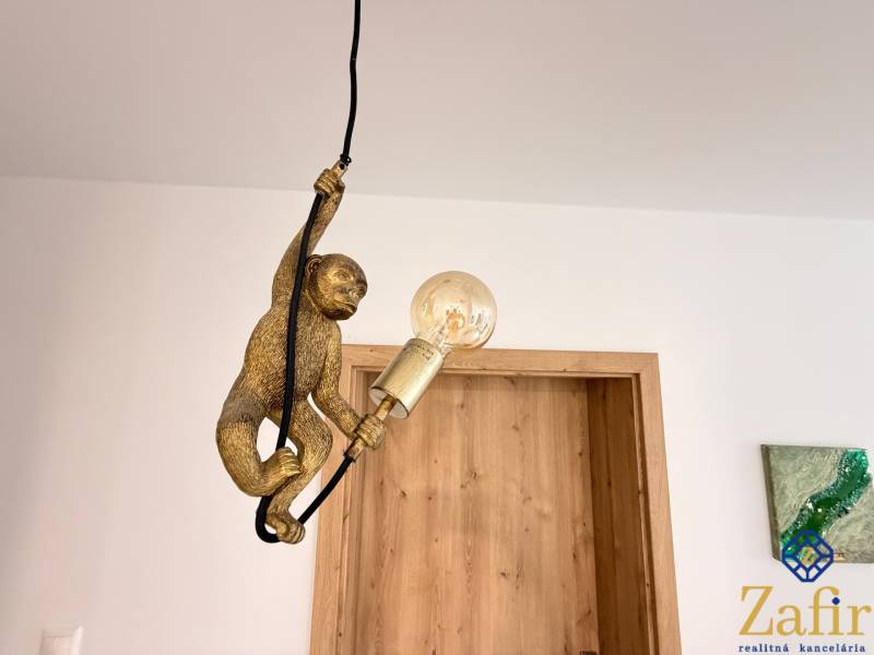 A designer lamp with a monkey motif in a family house.