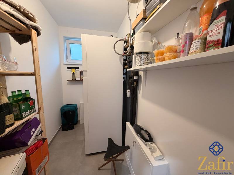 Storage space of a family house with a shelf, a bookshelf, and various goods.