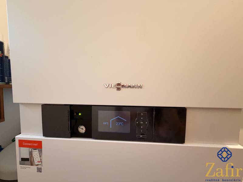 Viessmann brand condensing boiler with a digital display in a family house.