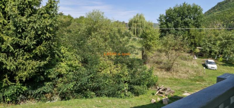 Greenery and a car in the exterior near Hollóháza, suitable for a 2-room apartment.