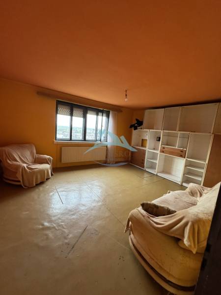 Living room in a family house with sofas and built-in storage cabinets.