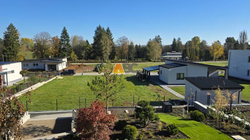 Kováčová offers residential plots with modern houses surrounded by greenery and trees.
