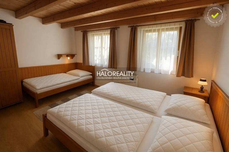 A bathroom in a cabin with tiled walls, a shower, a sink, and a mirror.