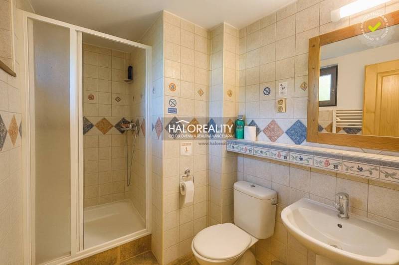 A cottage in Liptovský Mikuláš with wooden furniture on the terrace and a garden.