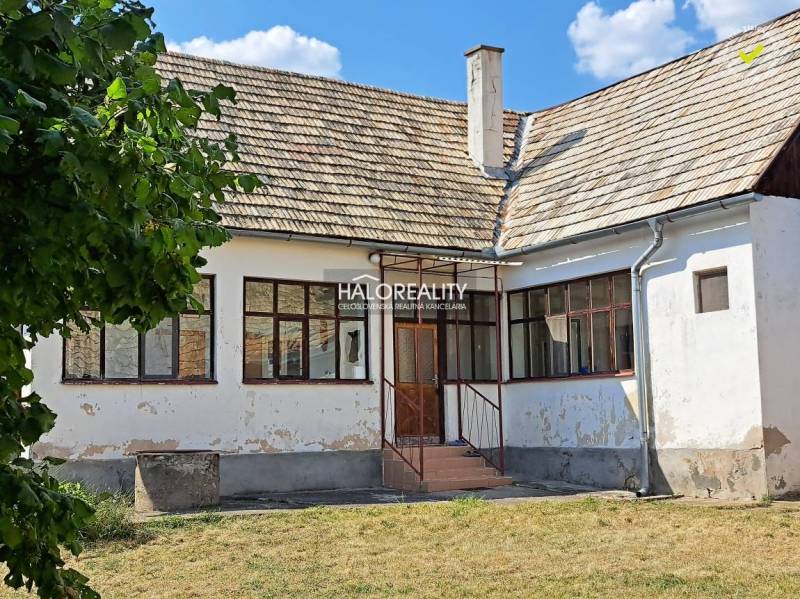 A family house in Zvolen with a white facade, wooden windows, and a gable roof.