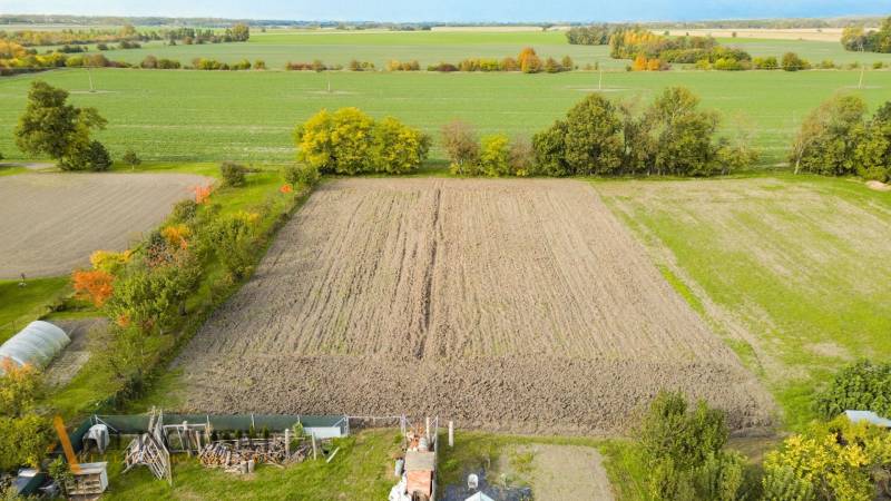 Extensive arable lands in Blahová surrounded by greenery and trees for living.