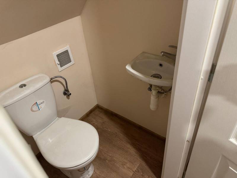 Small toilet with a sink and a wooden decor floor in Chata na Píle.