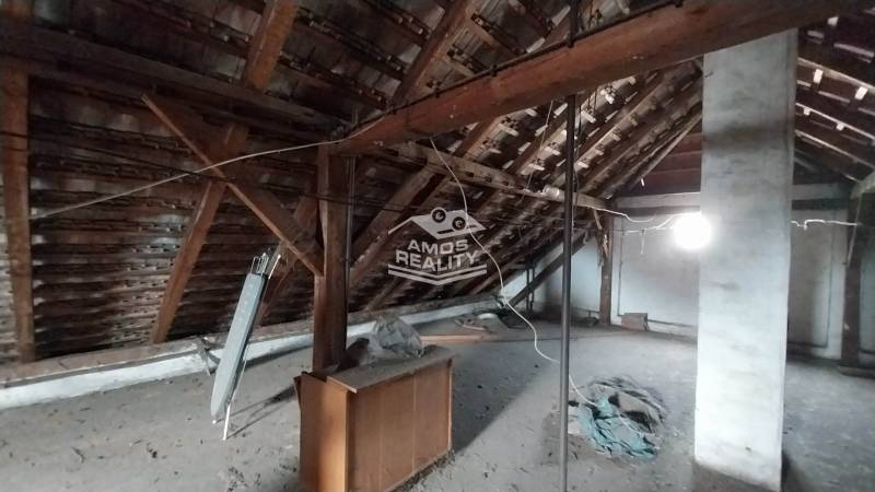 Attic of a family house on Štúrova, with wooden beams and clutter.