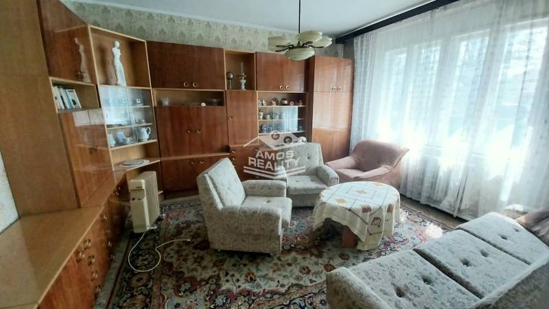 Living room on Štúrova Street, family house, sofa, wall unit, carpet, and armchairs.