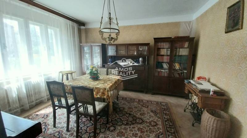 Living room with furniture on Štúrova Street in a family house, radiators, carpet, wallpaper.