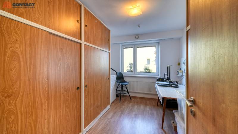 Interior of a family house with a wood-decor floor and large built-in wardrobes.