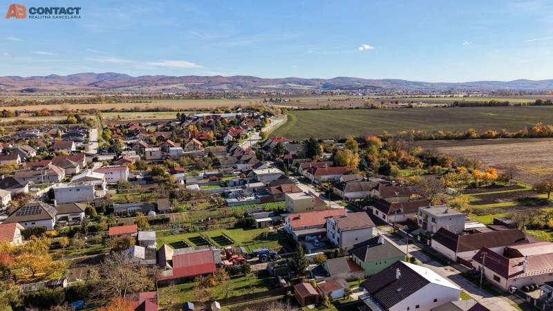 Aerial view of family houses on Južná Street in Veľké Orvište with picturesque countryside.