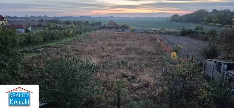 Building plots suitable for housing in Dvory nad Žitavou, surrounded by fields and greenery.