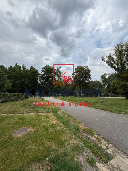 A park path surrounded by greenery on Lesnícka Street in Košice - West district.