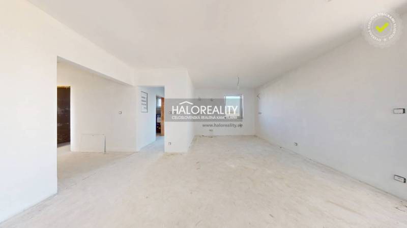 A spacious room with white walls in a family house, ready for renovations.