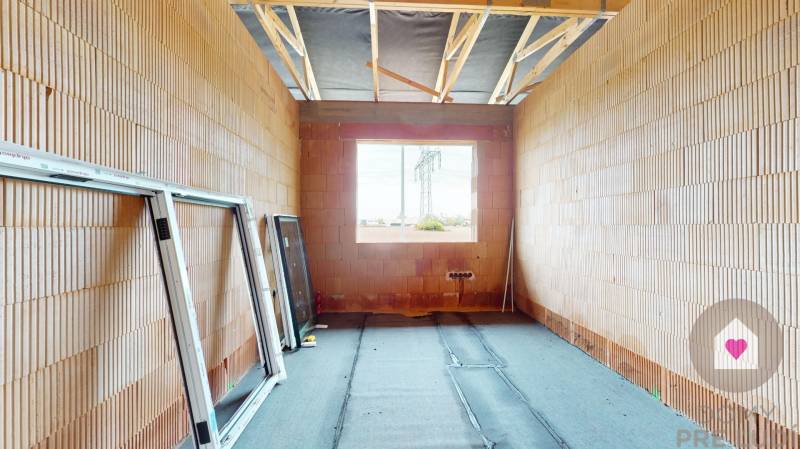Construction of a family house in Bernolákovo with windows ready for installation.