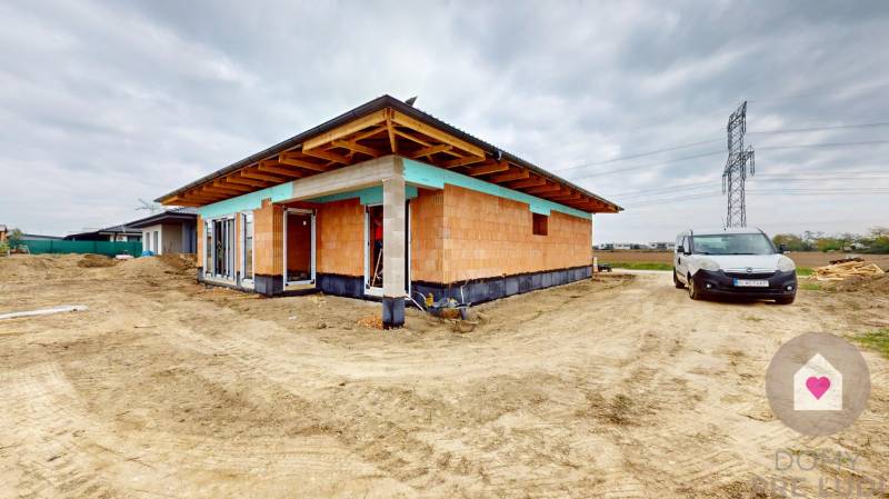 Family house under construction in Bernolákovo on undeveloped land with parking.