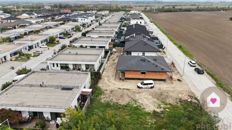 Residential housing area in Bernolákovo, surrounded by fields and paved roads.