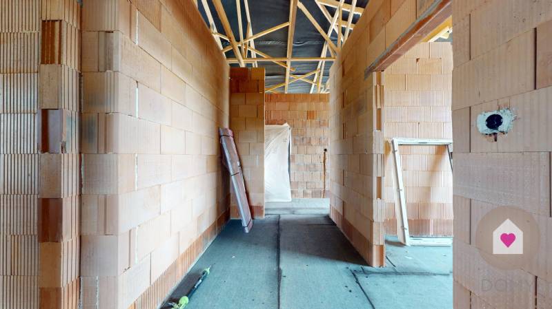 The interior of a family house with unfinished brick walls.