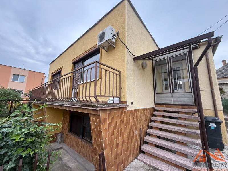 A family house on Jilemnického Street in Dvory nad Žitavou with external stairs and a balcony.