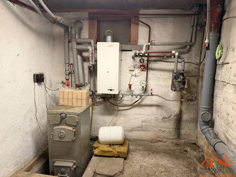 Boiler room in a family house with pipes and a boiler.
