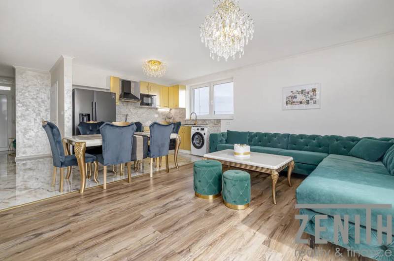 Living room in a family house with a wooden decor floor and luxurious furnishings.