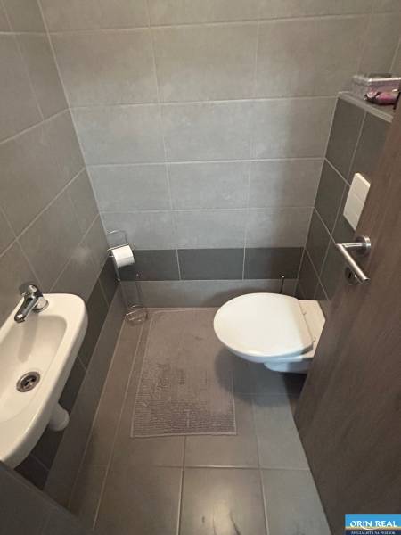 Bathroom with toilet and sink in a 2-room apartment.