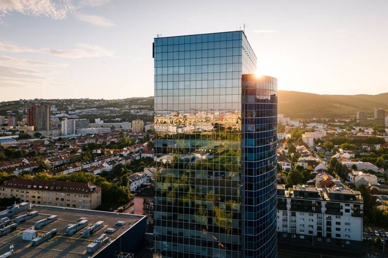 Panorama of Bratislava with the reflection of the city on a glass building, view from Vajnorská Street.