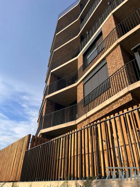 Apartment building in Bratislava-Petržalka with a brick facade and modern balconies.