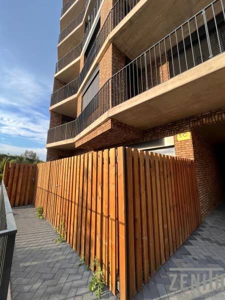 Apartment complex with a brick facade and a wooden fence in Bratislava - Petržalka.