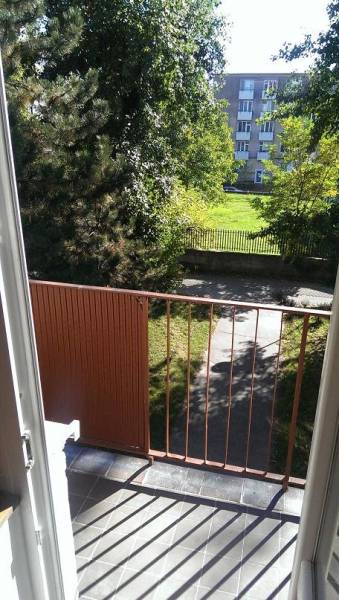 A balcony with a view of greenery and the sidewalk on Horná Street in Bratislava - Krasňany.