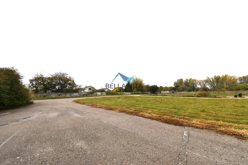 Commercial land in Galanta on Nebojsa Street, with an asphalt road and green surroundings.