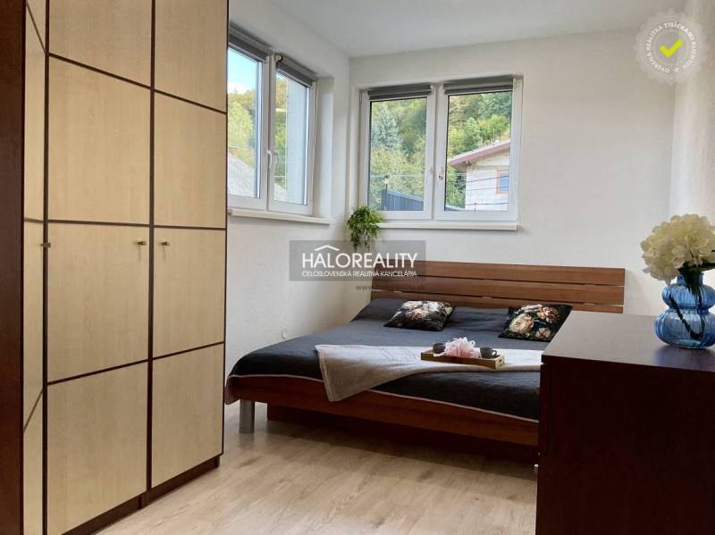 A bedroom in a 3-room apartment with a wood-patterned floor and large windows.