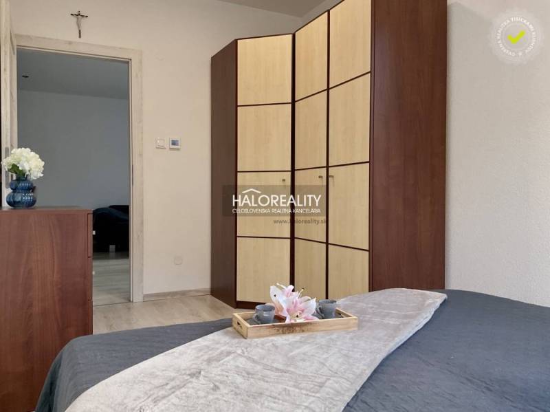A bedroom in a 3-room apartment with a large wardrobe and bed, wood decor.