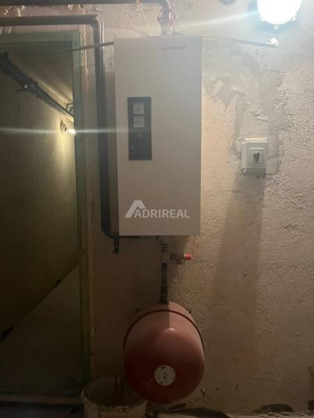 Boiler with a pressure tank in the utility room of a family house.