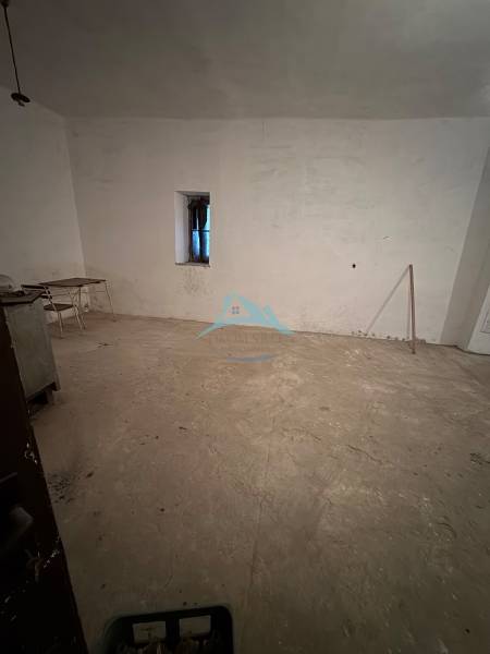 Empty room in a family house with a simple window and a chair.