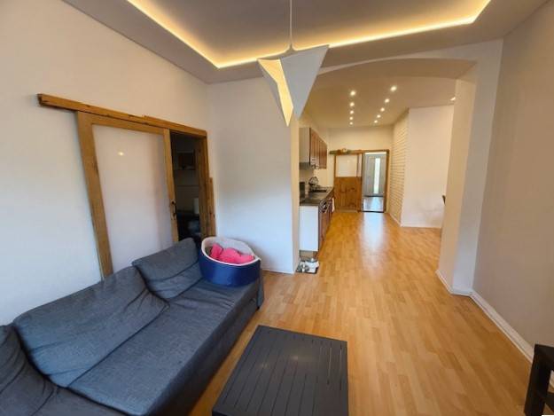 Living room in a family house with a sofa and a wooden decor floor.