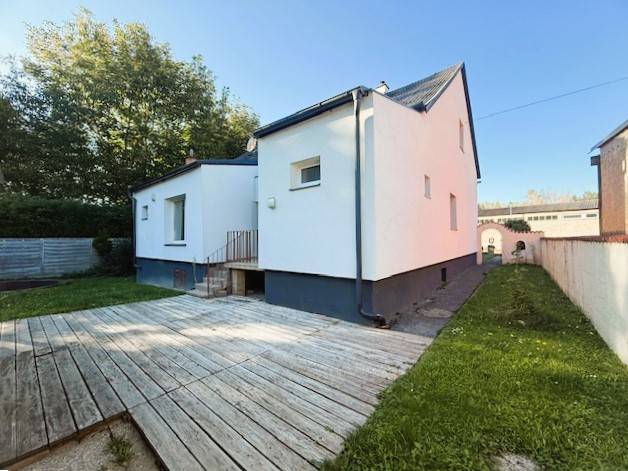Family house on Industriestraße in Hainburg an der Donau with a wooden terrace.