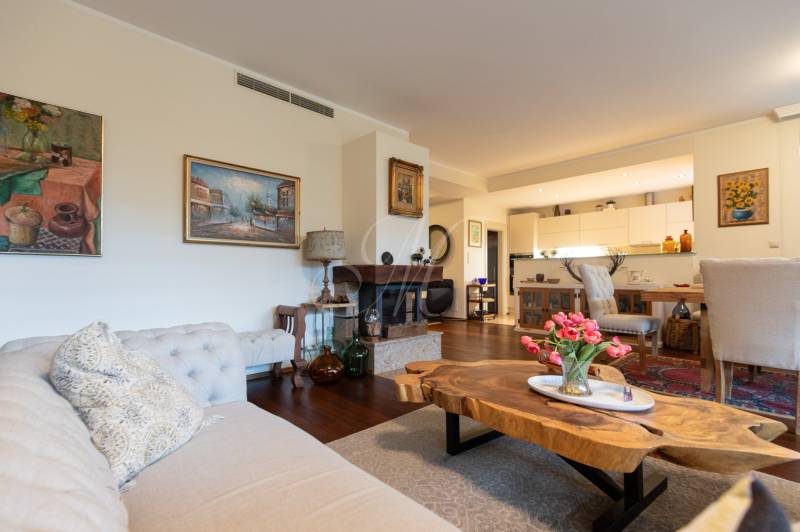A stylish living space with a sofa, floral decoration, and furniture in a 3-room apartment.