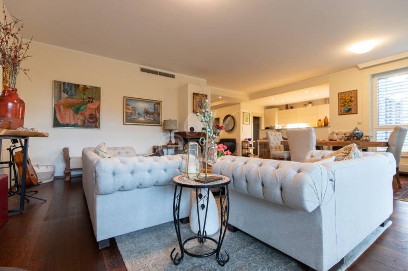 Living room in a 3-room apartment with sofas, armchairs, and a wooden decor floor.