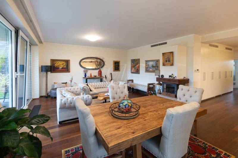 Living room in a three-room apartment with a wooden decor floor and stylish furniture.