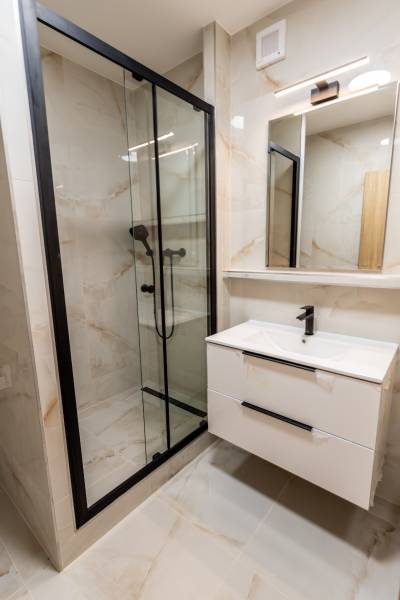 Bathroom in a 3-room apartment with a modern shower and sink.