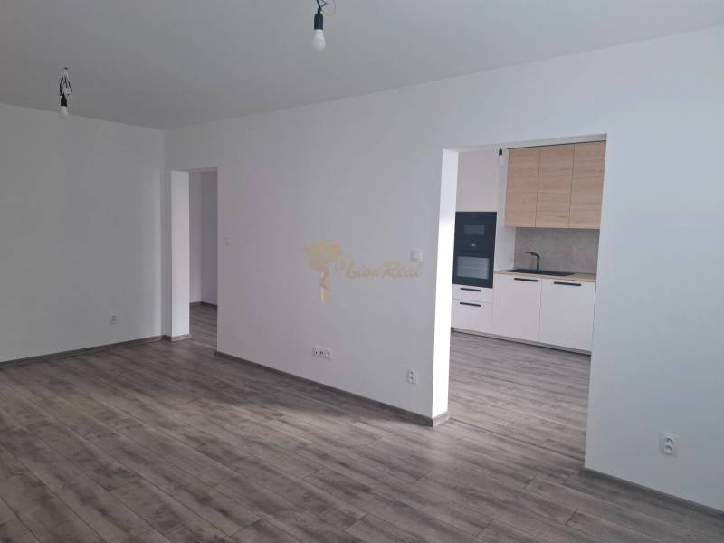 Living room with kitchen, wooden decor flooring, 3-room apartment.