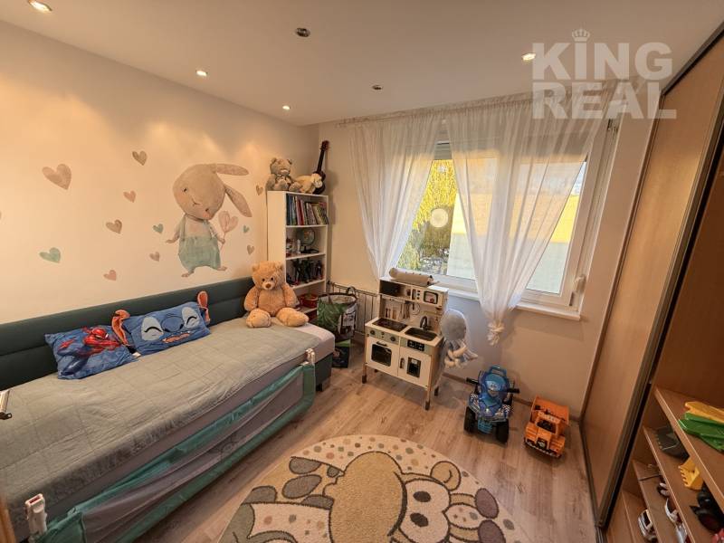 Children's room with a pull-out bed, toys, and shelves in a 3-room apartment.