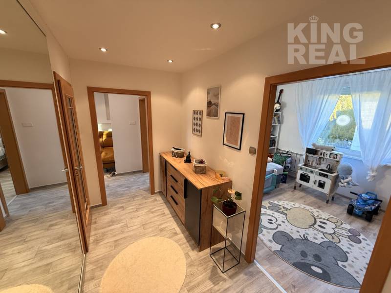 In the 3-room apartment, we see a hallway with decorative furniture and a children's room.