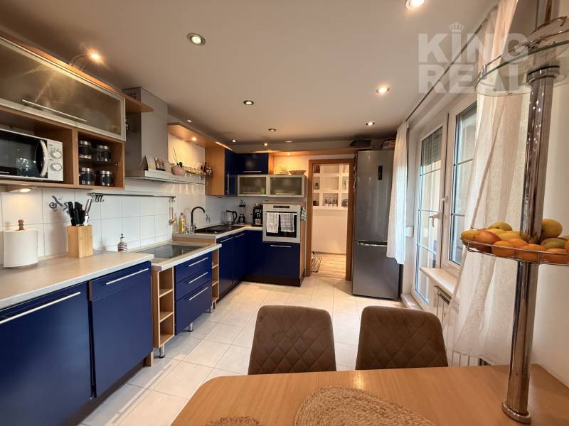 A kitchen in a 3-room apartment with blue cabinets and white walls.