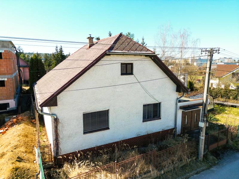 A family house on Na kopci Street in Žilina with a white facade and a sloped roof.