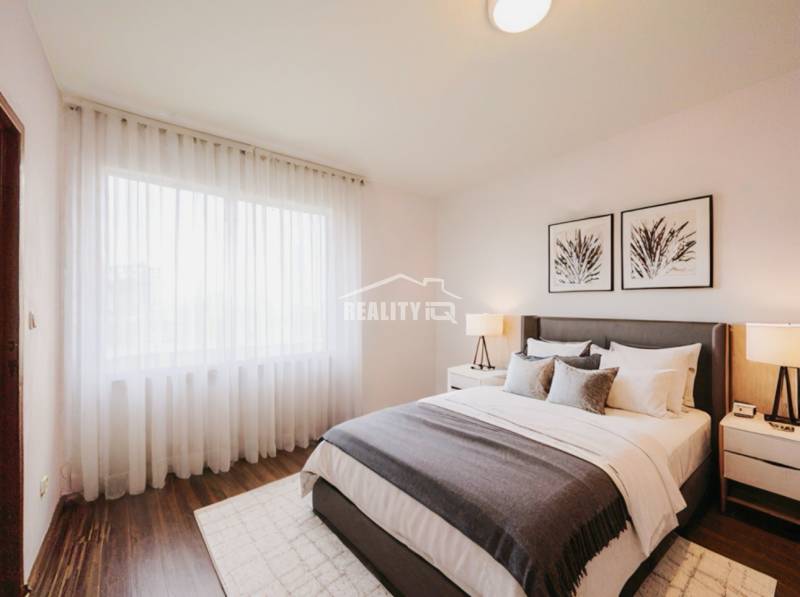 Bedroom in a 3-room apartment with a bed, nightstands, and a floor with a wooden decor.
