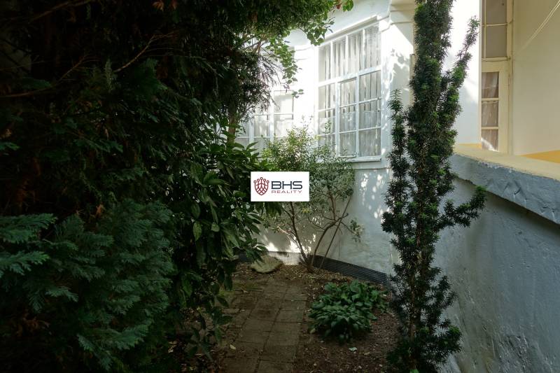 The garden of the family house on Hviezdoslavova Street in Piešťany, surrounded by greenery and shrubs.